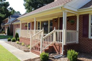 covered front porch of brick home